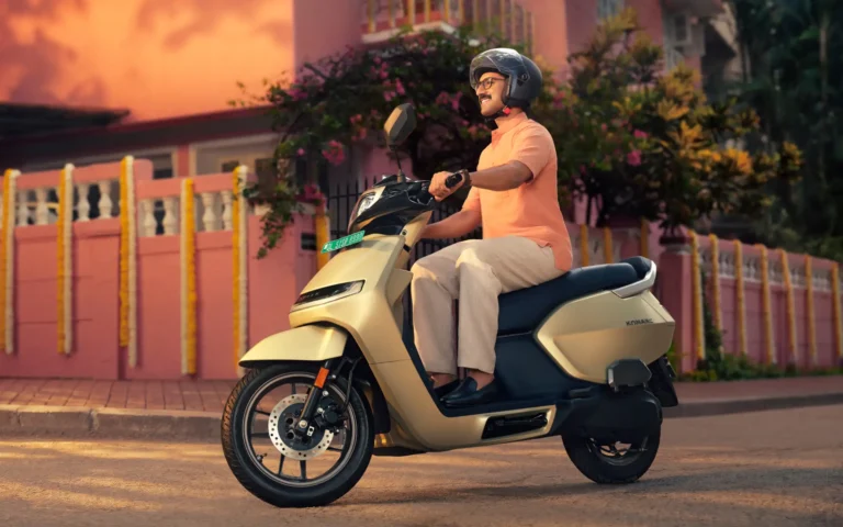 Rider on an Ather Konarc electric scooter outside a house